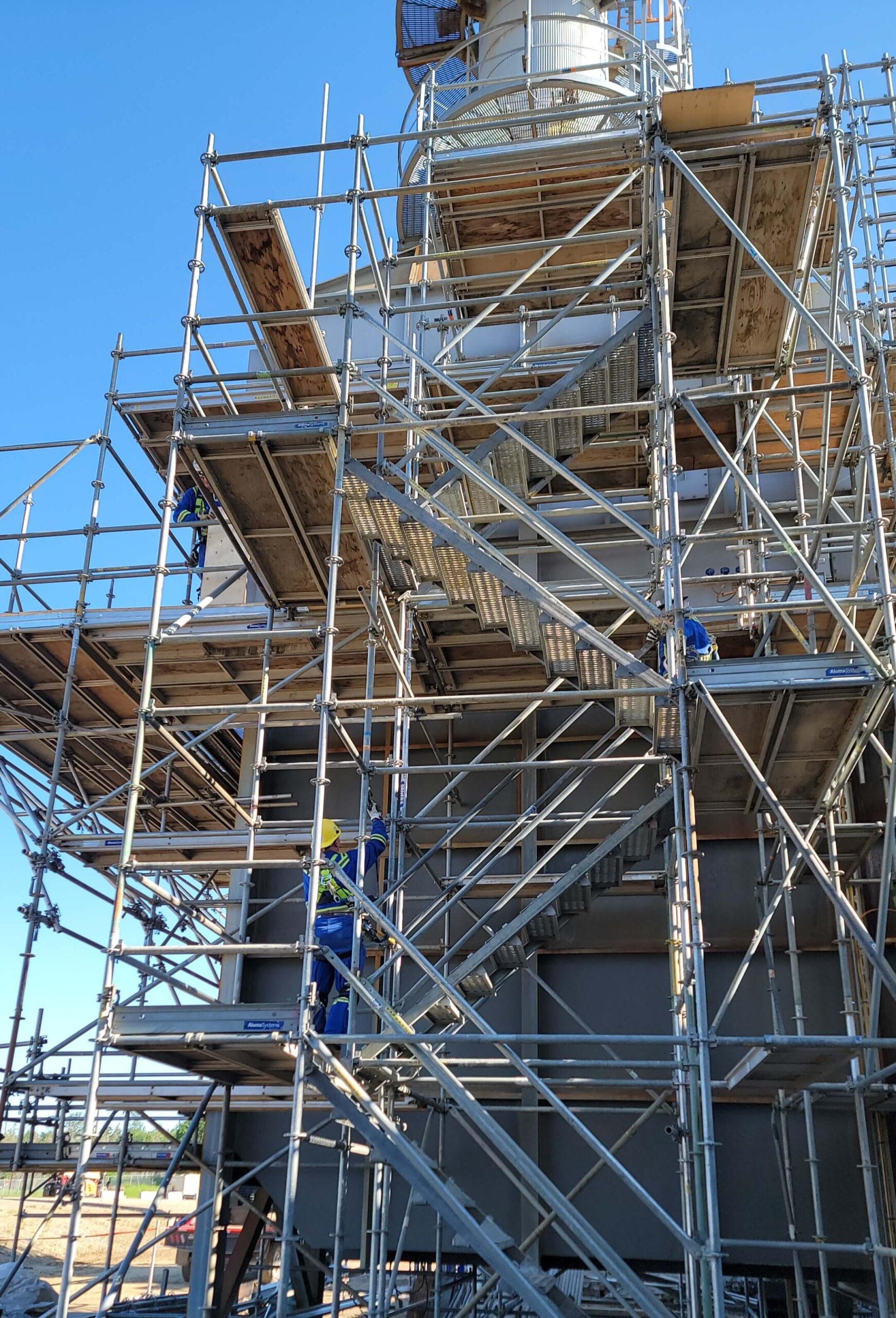 Another view of construction scaffolding in Alberta with a blue prairie sky in the background.